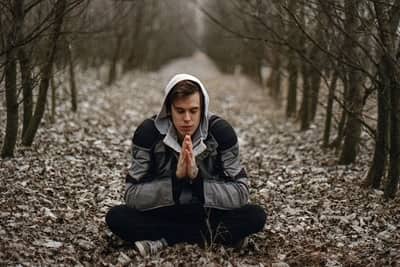 Man praying in woods