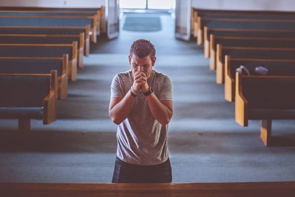 Man praying alone in church