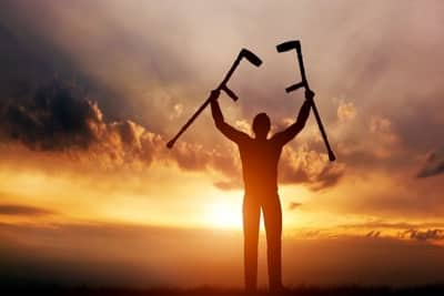 Man holding up crutches