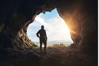 Man standing in cave entrance