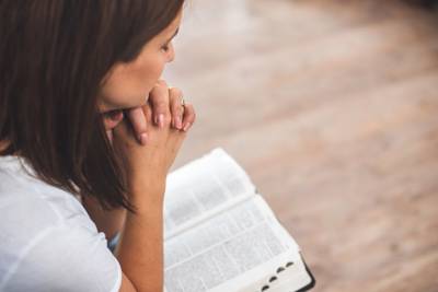 women praying over Bible to illustrate intimacy with God