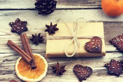 gift wrapped on a table with a orange slice next to it, symbolizing the fruits and gifts of the Spirit.